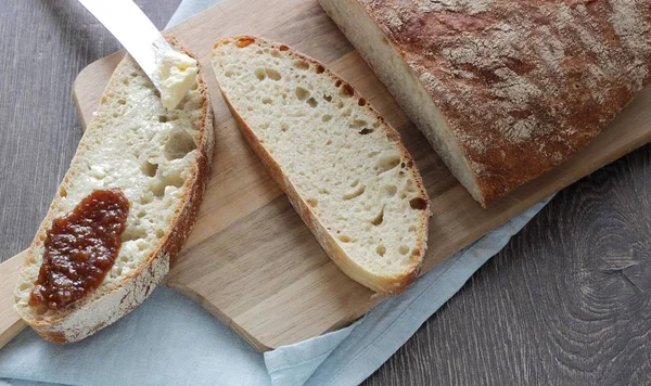 Homemade wheat bread with butter and jam