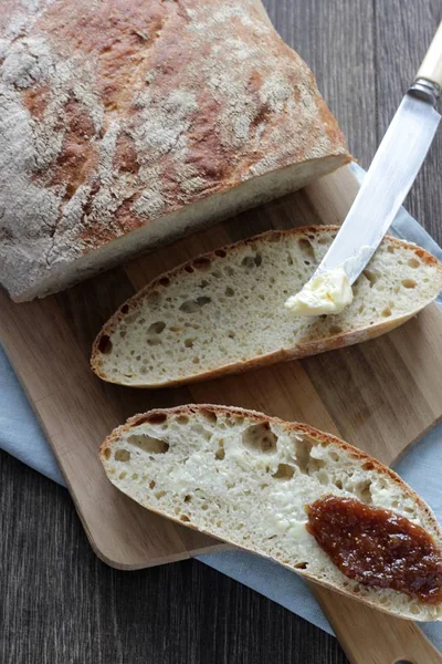 Homemade wheat bread with butter and jam