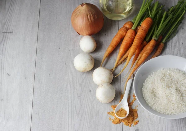 Malzemeler: pirinç, mantar, havuç ve soğan gri arka plan üzerinde. Kopya alanı