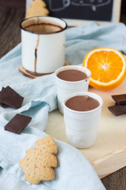 Sıcak çikolata veya kakao içki portakal ve tarçın sopayla gingerbread çerezleri ve çikolata parçaları ile servis.