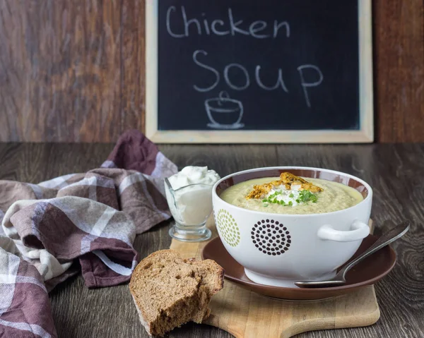 Pot of the hot chicken cram soup with mushrooms and leak decorated sour cream, herbs and chicken on brown table — Stock Image Pot Hot Chicken Cram Soup Mushrooms Leak Decorated Sour Cream Royalty Free Stock Photos
