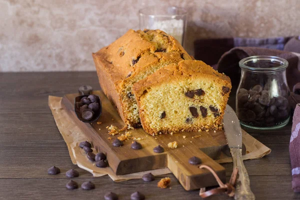 Homemade pound cake with chocolate drops on a wooden cutting board. Homemade pastry for breakfast or dessert.