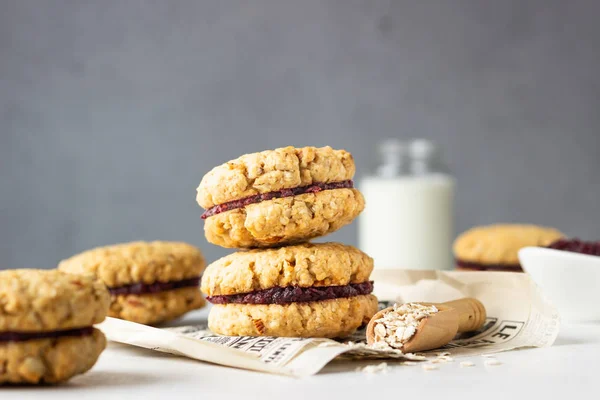 Vegan oat sandwich cookies with dried cranberry and orange filling, selective focus. Healthy breakfast or snack for children.