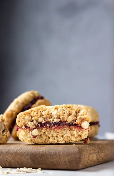 Vegan oat sandwich cookies with dried cranberry and orange filling, selective focus. Healthy breakfast or snack for children.