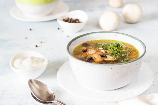 Homemade thick vegetarian mushroom soup with barley and vegetables with herbs in a ceramic bowl on a light grey stone background. Delicious cozy first course, comfort food. — Stock Image Homemade Thick Vegetarian Mushroom Soup Barley Vegetables Herbs Ceramic Bowl Stock Picture