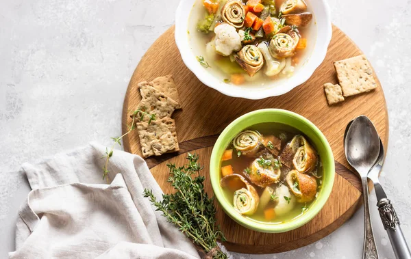 Vegetable soup with egg pancakes on light grey background. Traditional German Flaedlesuppe and Austrian Frittatensuppe. — Stock Image Vegetable Soup Egg Pancakes Light Grey Background Traditional German Flaedlesuppe Stock Image
