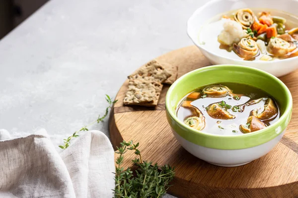 Vegetable soup with egg pancakes on light grey background. Traditional German Flaedlesuppe and Austrian Frittatensuppe. — Stock Image Vegetable Soup Egg Pancakes Light Grey Background Traditional German Flaedlesuppe Stock Image