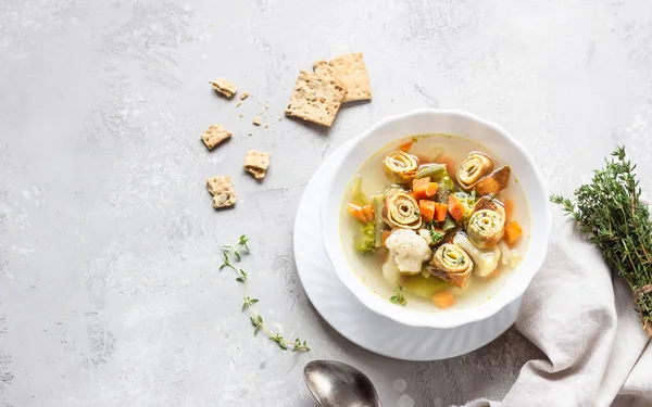Vegetable soup with egg pancakes on light grey background. Traditional German Flaedlesuppe and Austrian Frittatensuppe. — Stock Image Vegetable Soup Egg Pancakes Light Grey Background Traditional German Flaedlesuppe Royalty Free Stock Photos