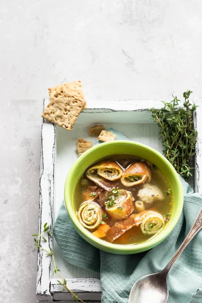 Vegetable soup with egg pancakes on light grey background. Traditional German Flaedlesuppe and Austrian Frittatensuppe. — Stock Image Vegetable Soup Egg Pancakes Light Grey Background Traditional German Flaedlesuppe Stock Photo