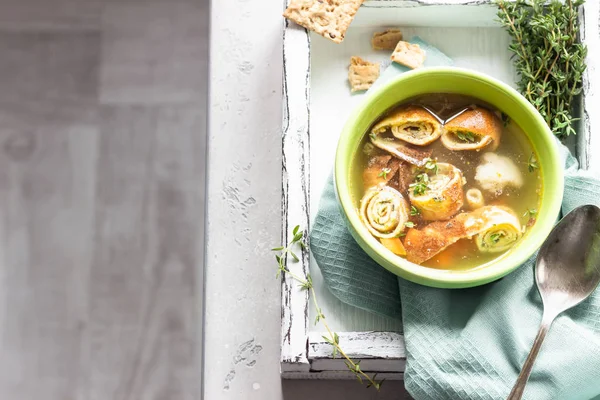 Vegetable soup with egg pancakes on light grey background. Traditional German Flaedlesuppe and Austrian Frittatensuppe. — Stock Image Vegetable Soup Egg Pancakes Light Grey Background Traditional German Flaedlesuppe Royalty Free Stock Photos