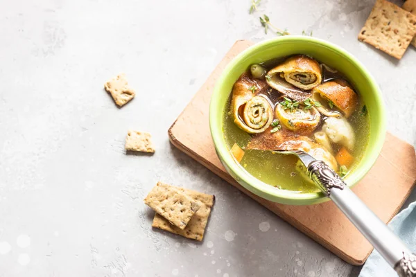 Vegetable soup with egg pancakes on light grey background. Traditional German Flaedlesuppe and Austrian Frittatensuppe. — Stock Image Vegetable Soup Egg Pancakes Light Grey Background Traditional German Flaedlesuppe Royalty Free Stock Images