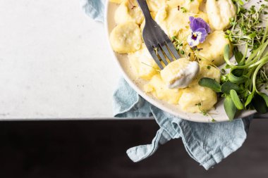 Kremalı ve peynirli börekler seramik tabakta mikro yeşillik ve ekşi kremayla servis ediliyor. Geleneksel Ukrayna ya da Rus tembel köfteleri (vareniki). Sağlıklı kahvaltı.. 