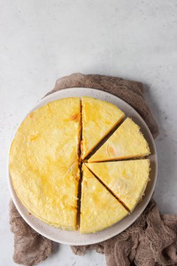 Karamel soslu balkabaklı cheesecake, açık gri taşlı arka plan. Seçici odak. 