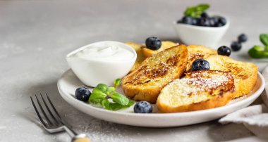 Geleneksel İspanyol usulü kızarmış ekmek, yaban mersinli torrijalar ve seramik tabakta nane şekeri. Paskalya ve Paskalya için tipik bir tatlı.. 