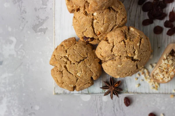 Homemade vegan cookies with buckwheat, raisin and nuts. Healthy sweet snack. Light grey stone background.