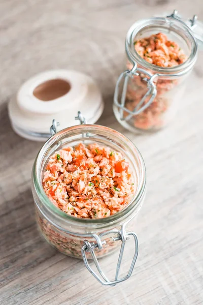 Roasted and smoked salmon fish, soft cheese and egg pate in glass jar, selective focus