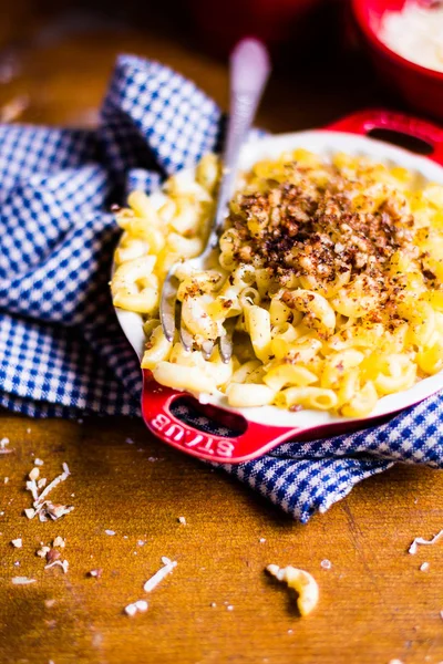 Baked macaroni and cheese in a bowl, top view, selective focus