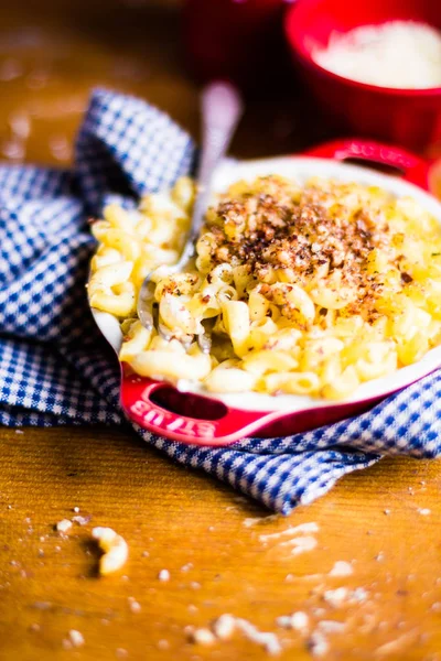 Baked macaroni and cheese in a bowl, top view, selective focus