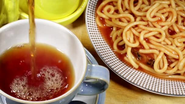 Pouring Tea With Spaghetti on Toast Breakfast Food