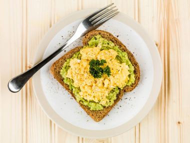Scrambles Eggs and Avocado on Toasted Wholemeal Brown Bread clipart