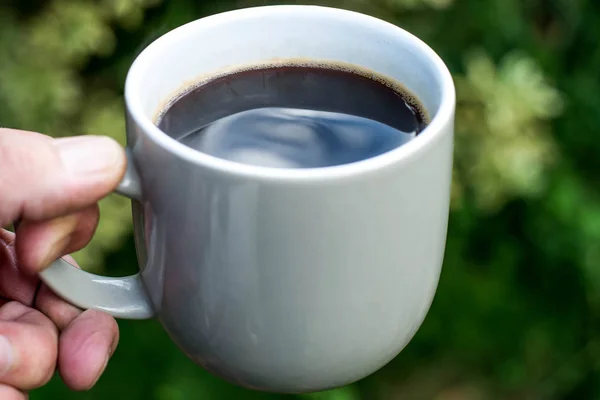 Man håller en mugg svart kaffe — Stockfoto