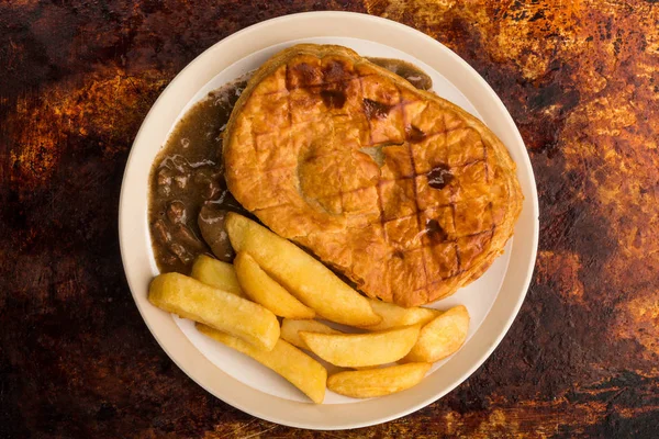 Beef Steak Pie With A Puff Pastry Crust Top And Chips — Stock Photo, Image