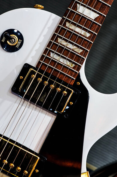 Close Up of a White Electric Steel String Guitar