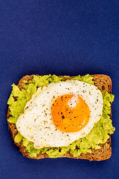 Uovo fritto lato soleggiato su Avocado schiacciato e pane di segale Open Face Sandwich — Foto Stock