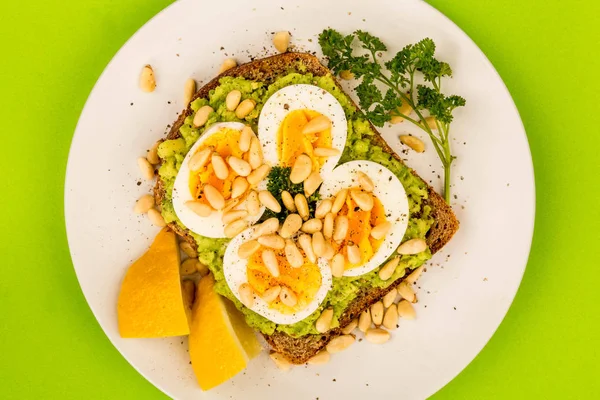 Boiled Egg on Crushed Avocado With Pine Nuts And Rye Bread Open Sandwich — Stock Photo, Image