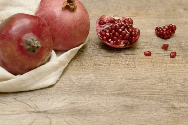 Ripe Pomegranates White Bag Wooden Table Fruit Fresh Background — Stock Photo, Image