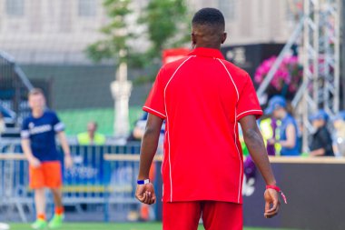 young black soccer player in red uniform
