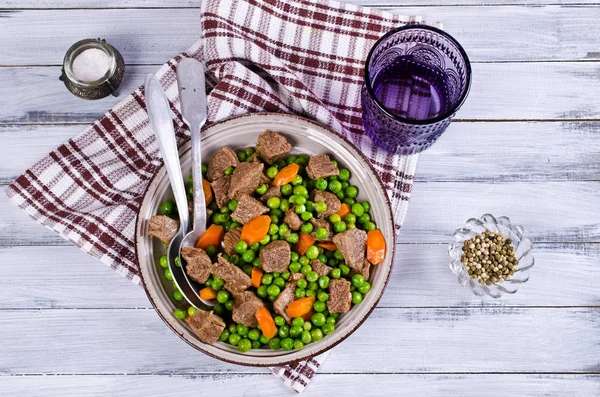 Meat stew with peas and carrots