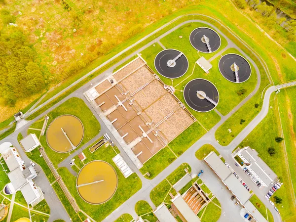 Aerial view to biogas plant from sewage treatment in green fields