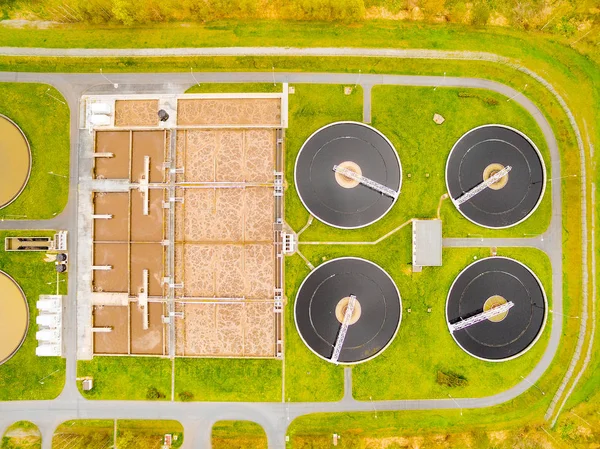 Aerial view to biogas plant from sewage treatment in green fields