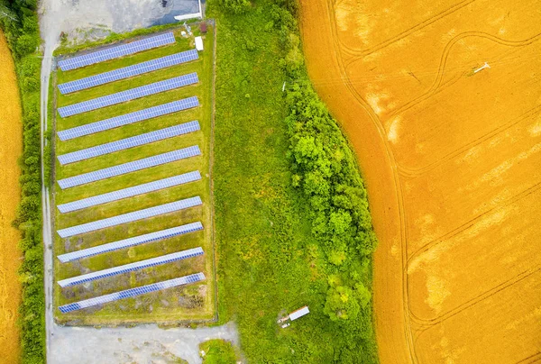 Vista aérea para usina de energia solar no campo de trigo — Fotografia de Stock