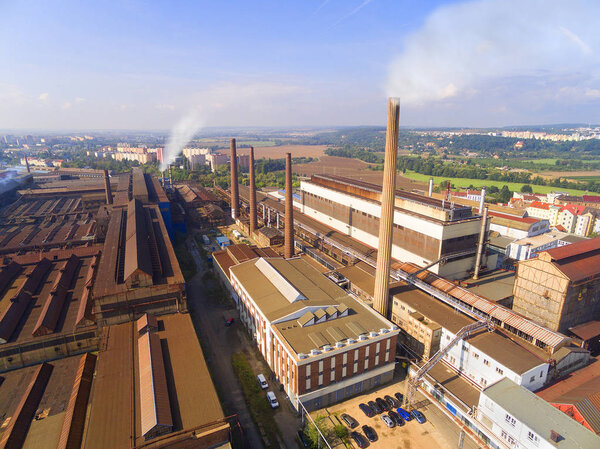 Aerial view of industrial zone with fuming chimneys.  Heavy industry from above. Steelworks in Pilsen, Czech Republic, European Union. 