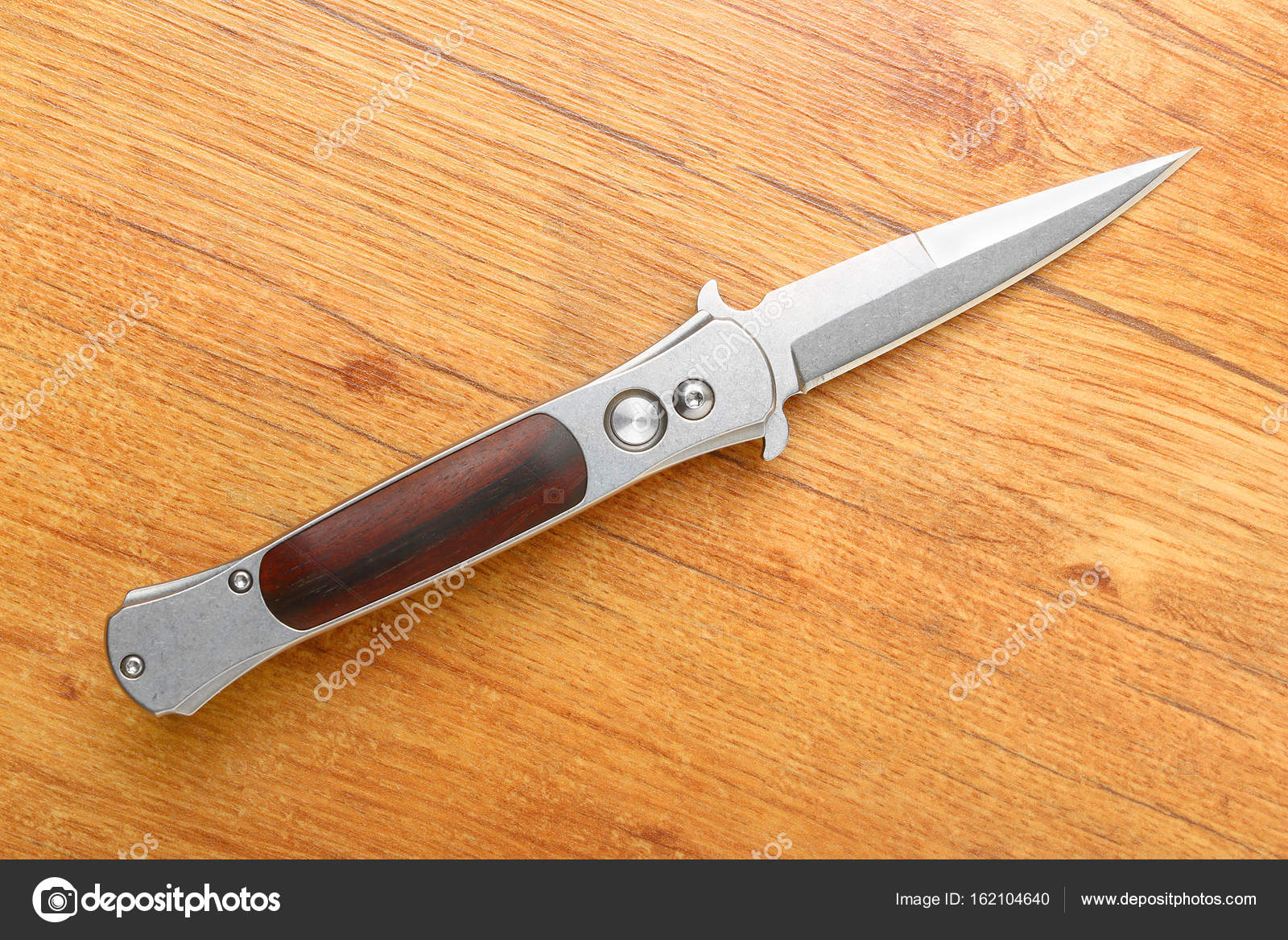 Automatic spring locking folding knife from stainless steel Stock Photo