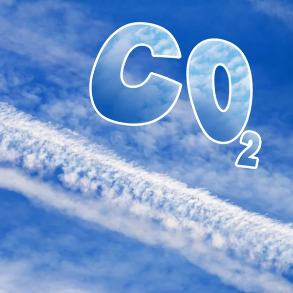 Symbol of carbon dioxide on blue sky with aircraft trails — Stock Photo, Image