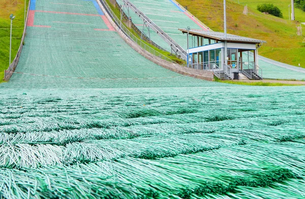 A dry ski slope or artificial ski slope closeup. This a ski slope mimics the attributes of snow using materials that are stable at room temperature.