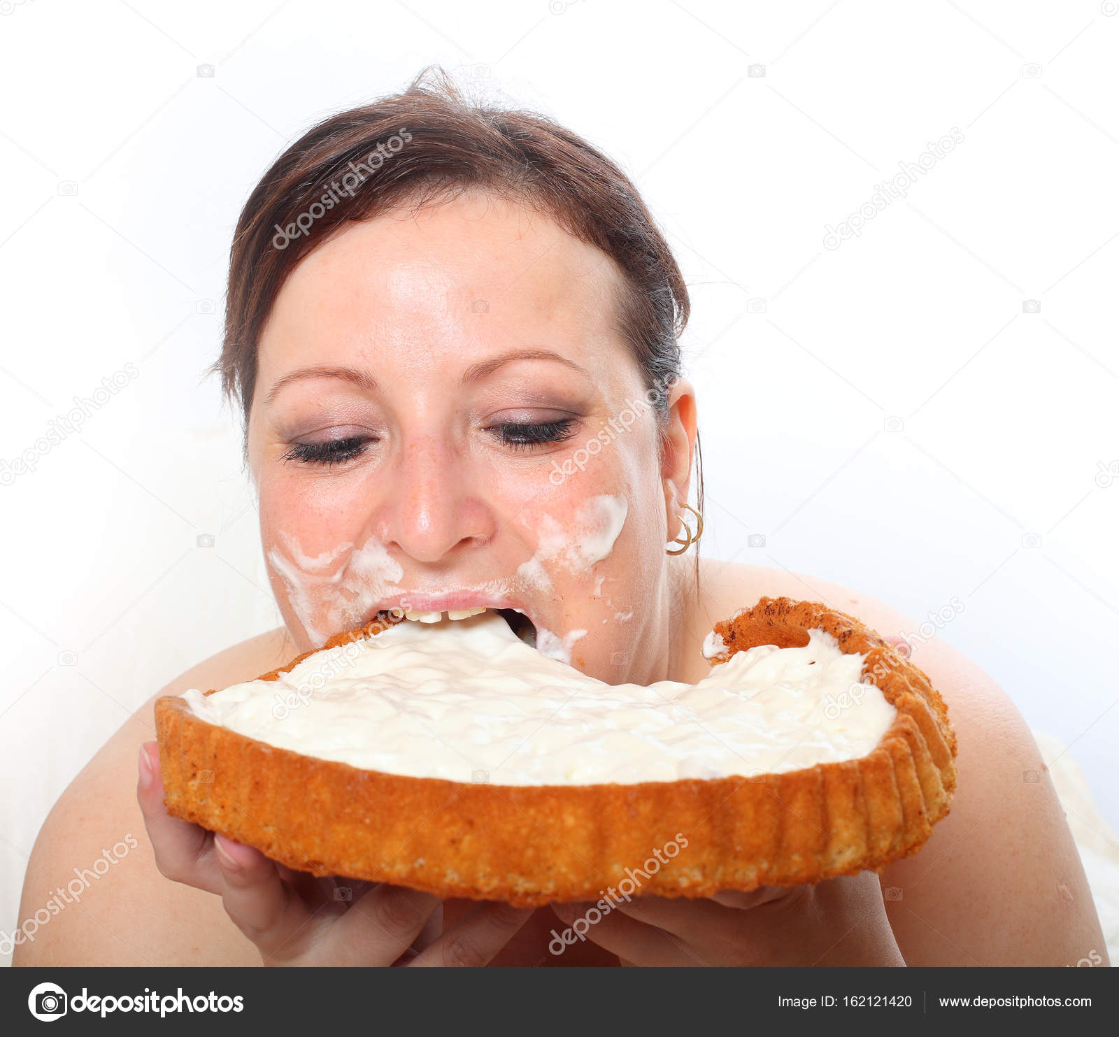 Overweight woman eating sweet cream cake — Stock Photo © vladvitek