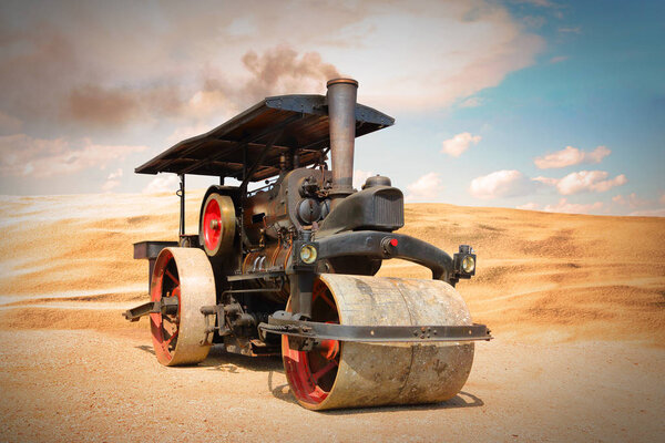 Old steam roller on desert.