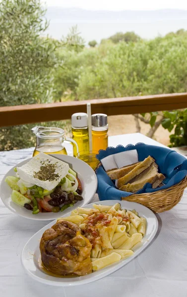 Greek food classic veal stifada with pasta Greek salad crusty br — Stock Photo, Image