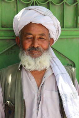 Afgan adam ayakta ve evinin kapısında poz