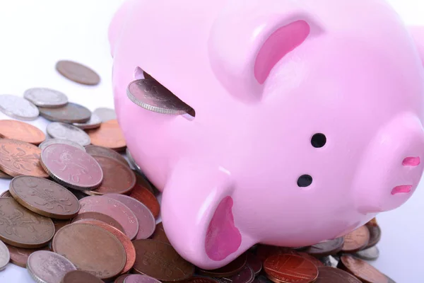 Piggy bank on side pouring money — Stock Photo, Image