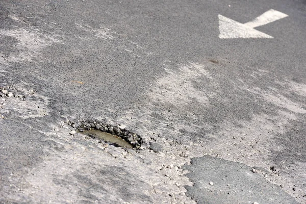 それを指す矢印の道路の路面の穴 ロイヤリティフリーのストック画像