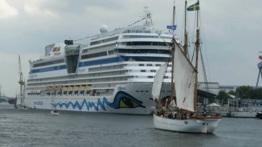 Warnemuende, Mecklenburg-Vorpommern / Almanya 13 Ağustos 2016: Aida mar cruise Limanı Warnemuende gemisiyle Hanse Yelken olay sırasında. Yelkenli tekneler tarafından geçen bir sürü