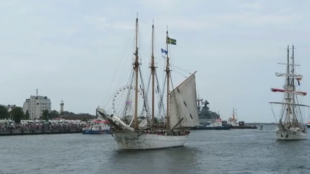 WARNEMUENDE, Mecklenburg-Vorpommern/ GERMANY AUGUST 13 2016: historical sailing boats and schooner sailing along the Rostock Harbor at Warnemuende during Hanse Sail weekend event. — Stock Video