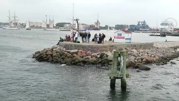 WARNEMUENDE, Mecklenburg-Vorpommern / GERMANY AUGUST 13 2016: passing by the cityscape of Warnemuende and its harbor with a tourist boat. Hanse sail weekend . — стоковое видео