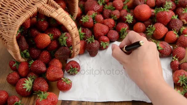 Strawberries basket on wooden table. jam making. ghost writing on blank notepaper copyspace — Stock Video