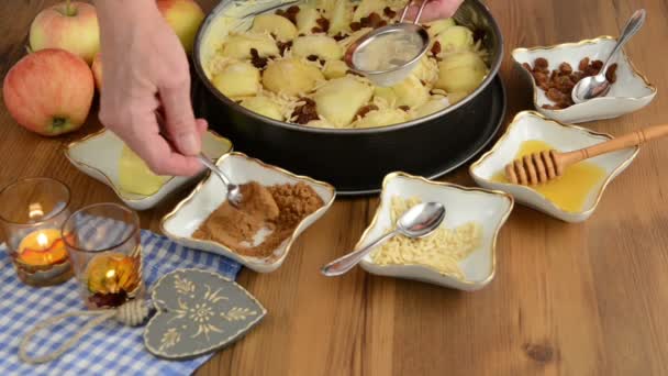 Pastel de manzana horneado. Espolvoreado canela en el pastel de manzana cruda. Además, hay ingredientes como miel, canela, astillas de almendras , — Vídeo de stock